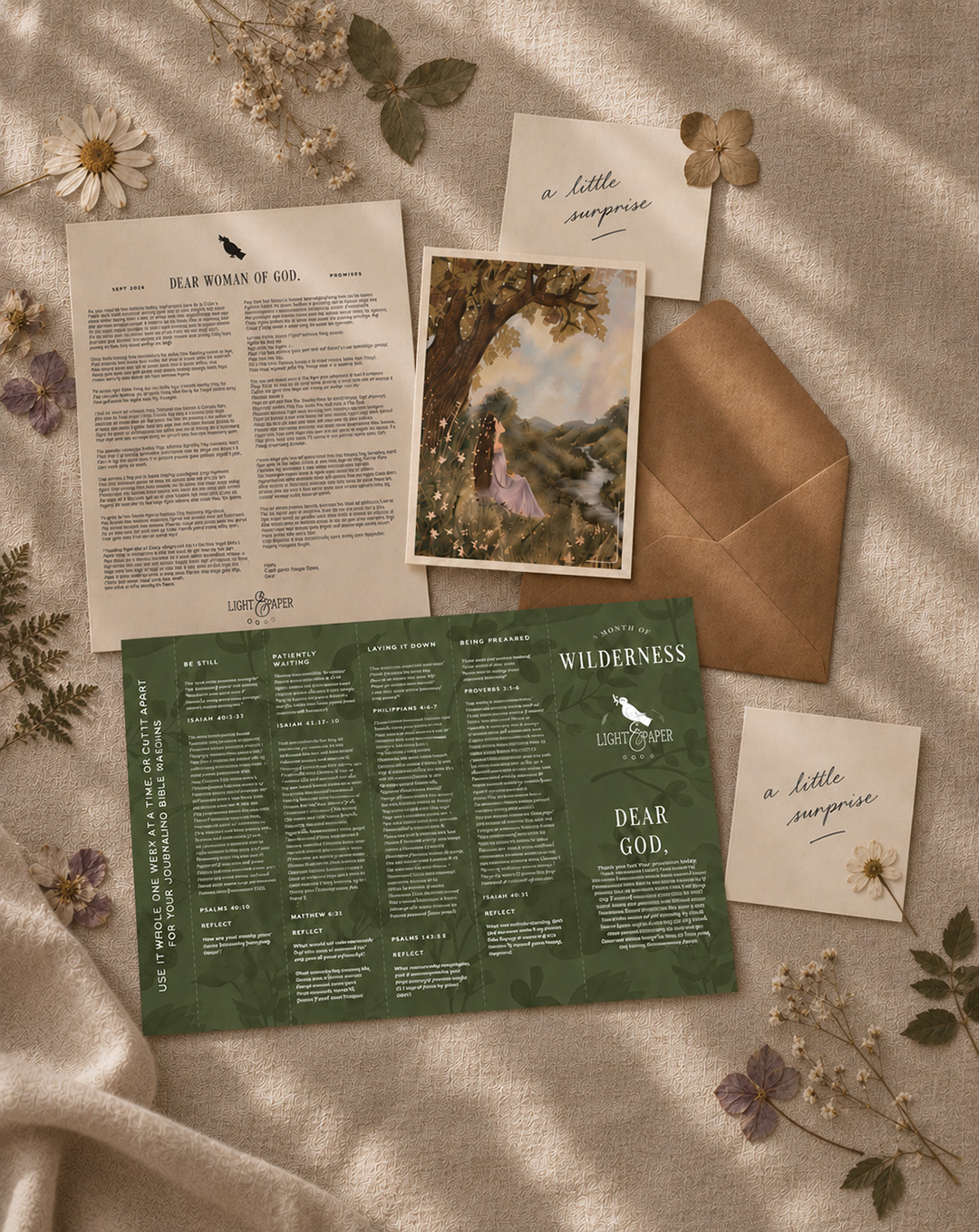 October's "Wilderness" themed letter, artwork print, envelope, and keepsakes laid out together